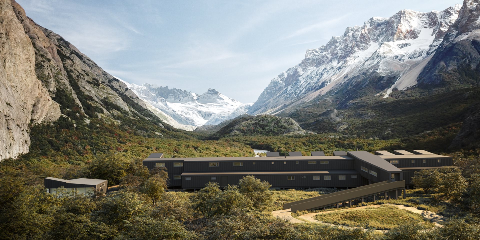 A long building in the jungle, with snowy mountains in the background